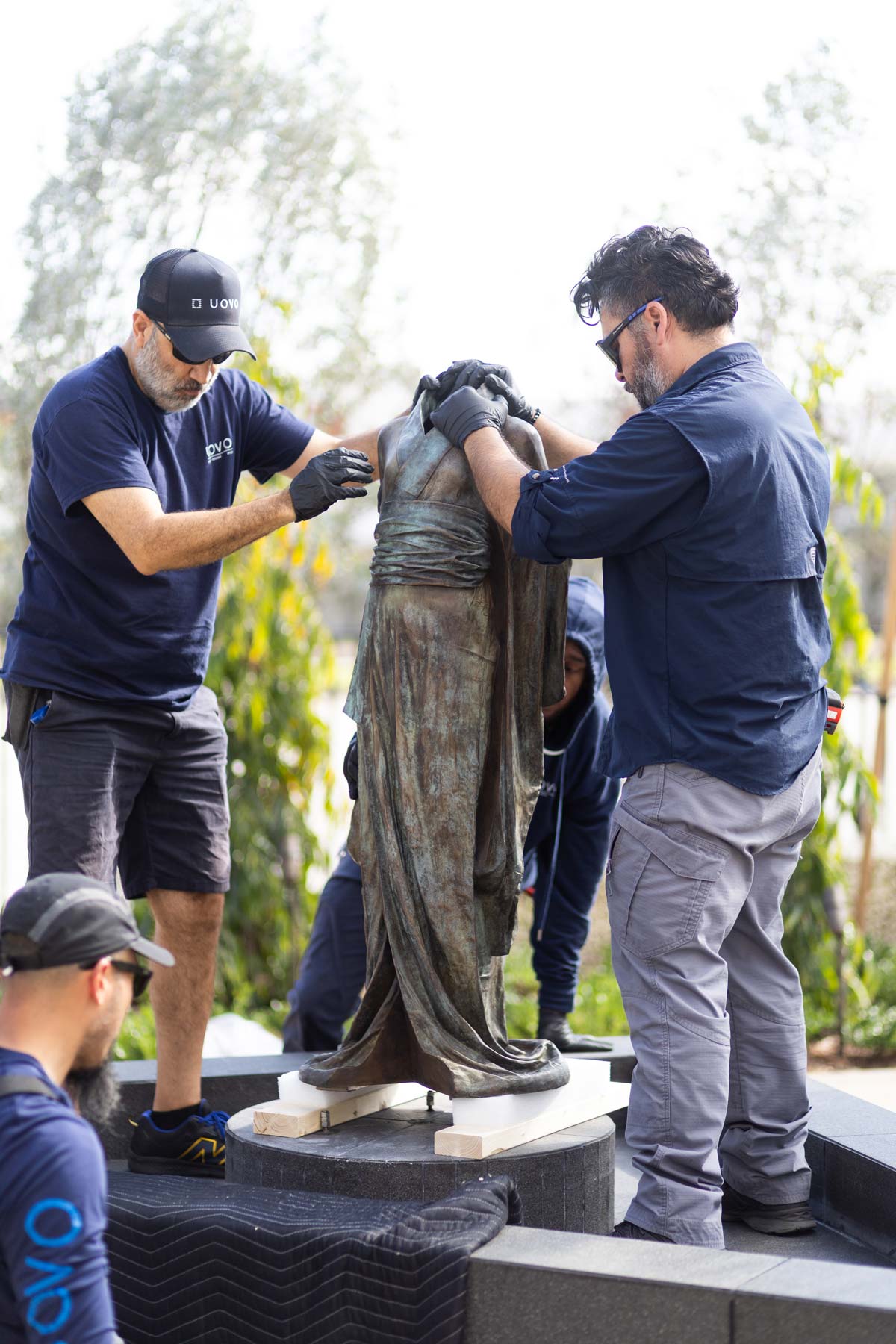 installing cast bronze sculpture entitled Hanako by artist Karen LaMonte, photo by Heather Holt