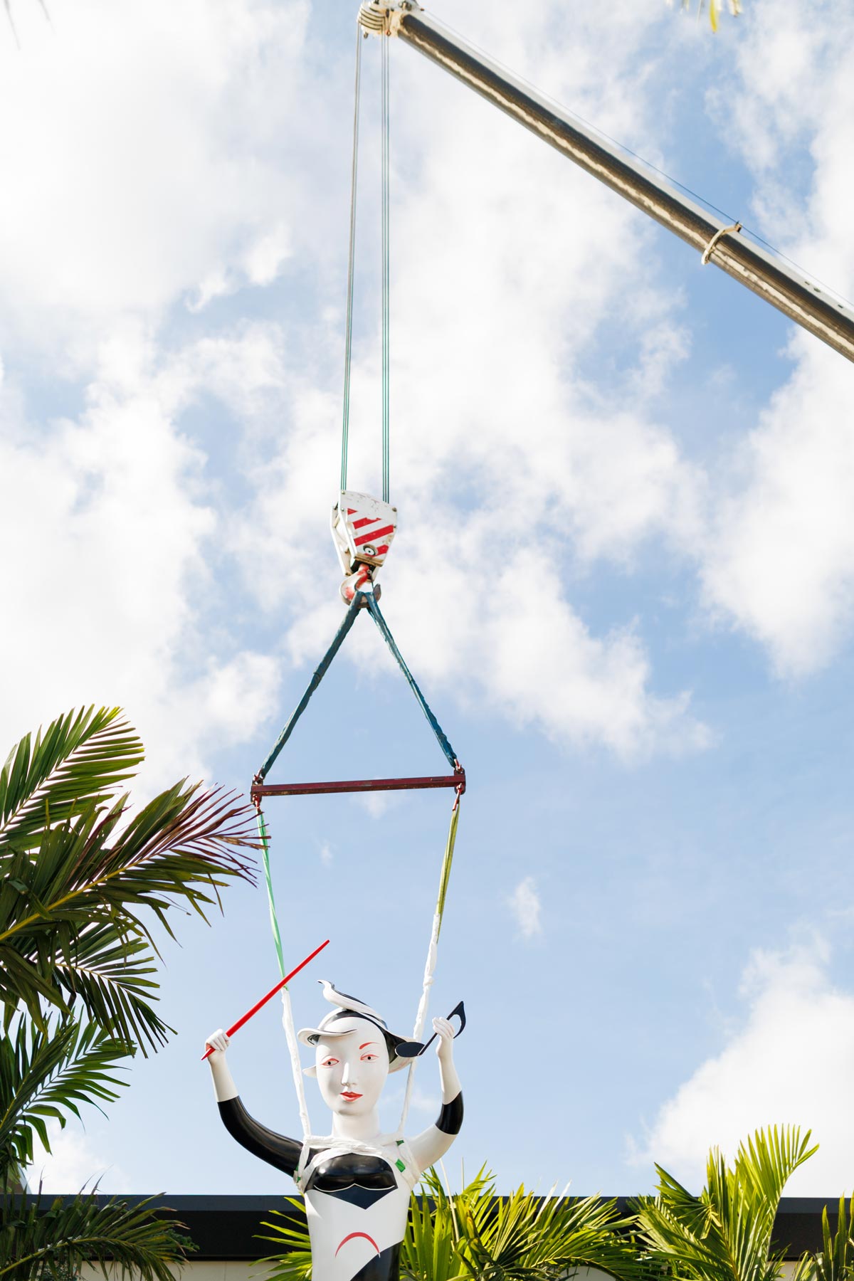 installing cast aluminum and paint sculpture entitled Harmony by artist Patti Warashina, photo by Heather Holt