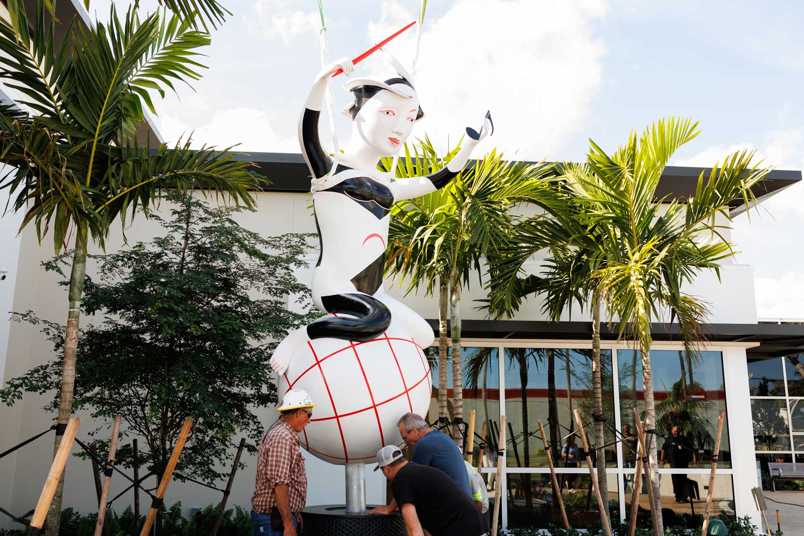 installing cast aluminum and paint sculpture entitled Harmony by artist Patti Warashina, photo by Heather Holt