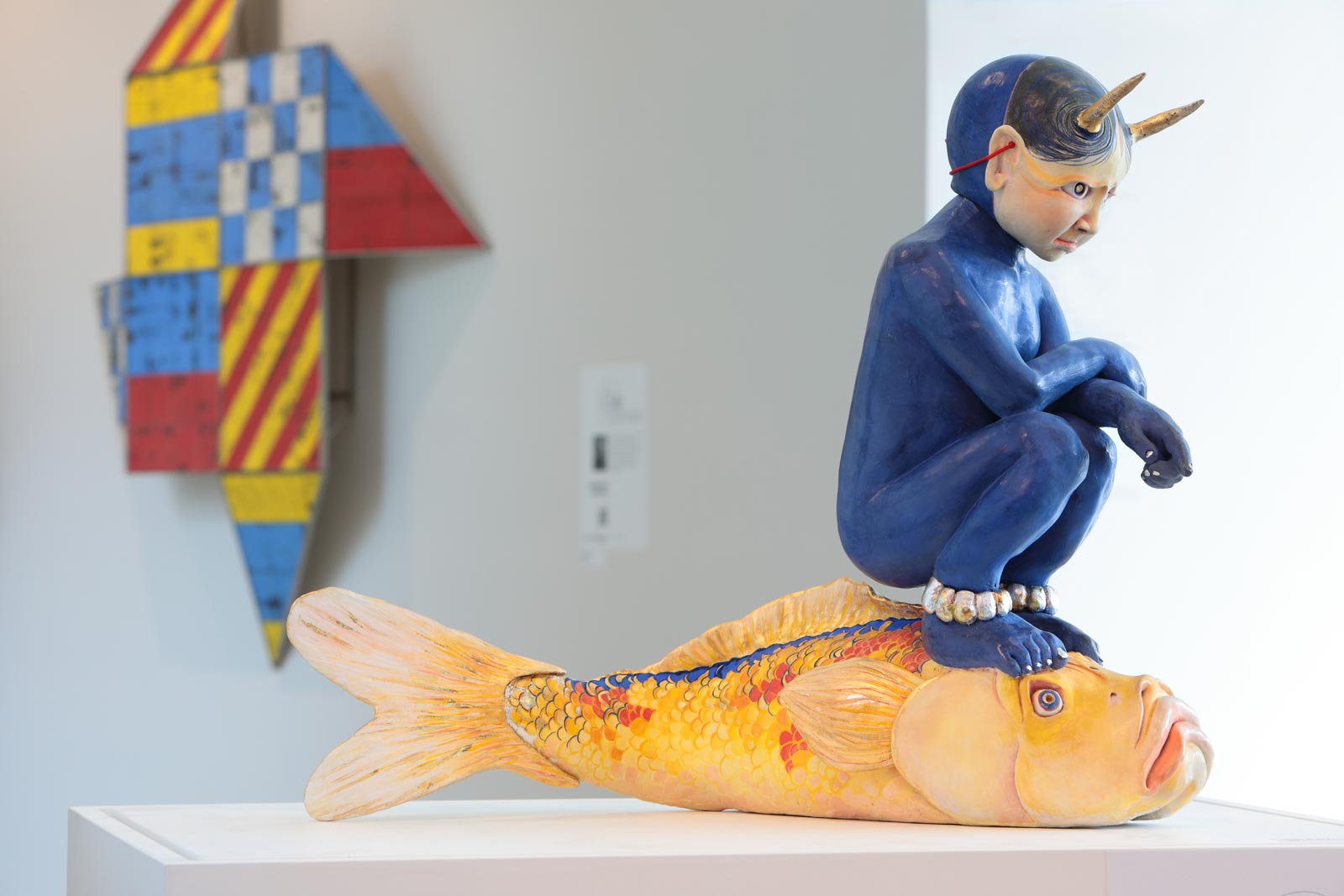 ceramic highlights from the collection including Hanako O’Leary's sculpture titled Kokoro no Oni (Demon of the Heart), clay and mixed media; in background is Jeremy Jernegan's wall hanging piece titled Pinwheel: DENY, glazed ceramic and stainless steel; photo by David Hunter Hale